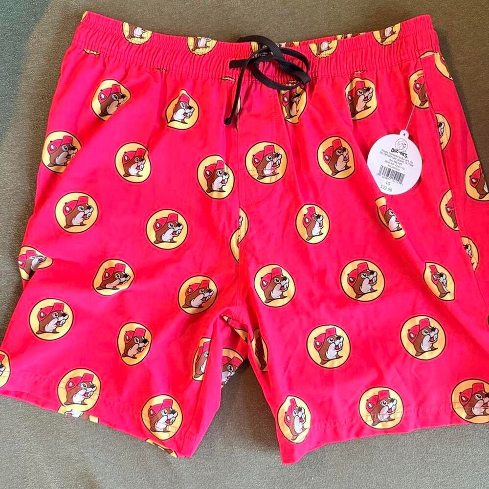 Buc-ee's reddish pink swim trunks